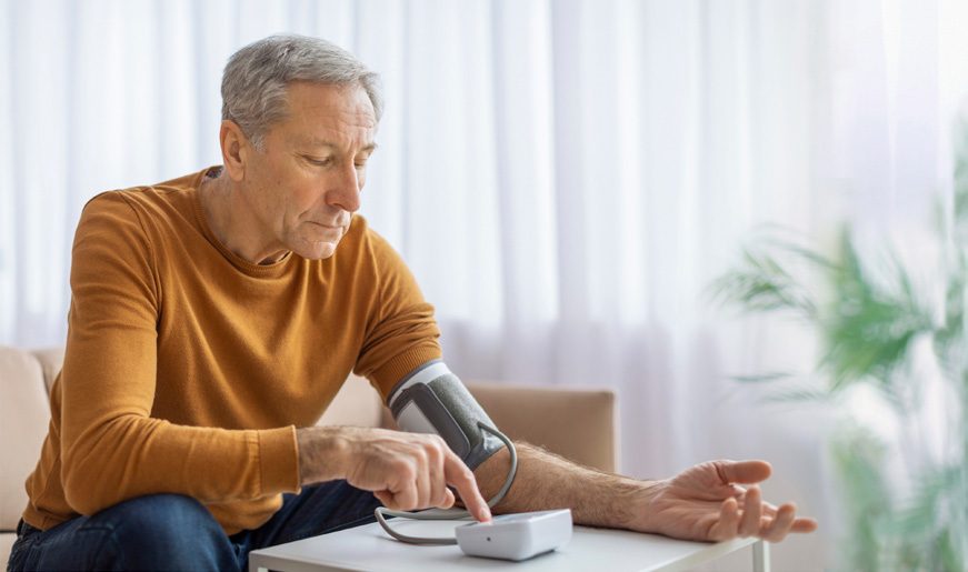 Patient using a connected blood pressure monitor at home